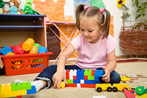 Little Girl Playing with Toys